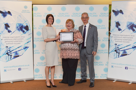 Anne McGuigan & Vincent Iles receiving a Committed to Excellence award on behalf of The Richmond Fellowship Scotland from Quality Scotland CEO Claire Ford
