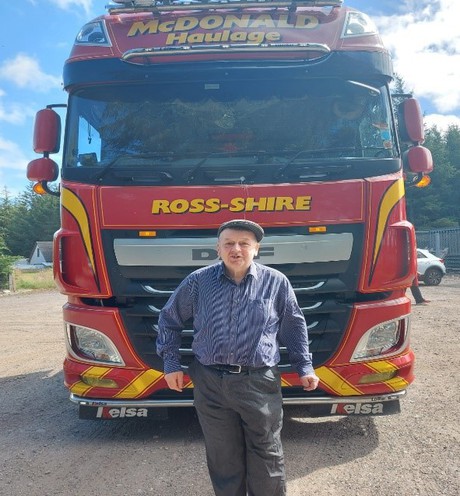 Reggie in front of lorry