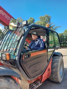 Reggie driving forklift